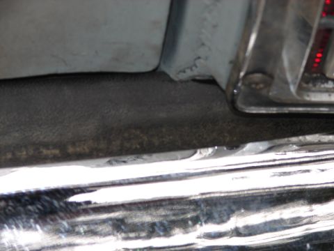 1973 Ford Ranchero - Detail shot of a vehicle's rear bumper and tail light housing.