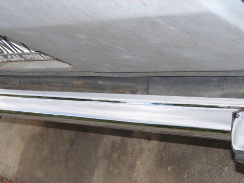 1973 Ford Ranchero - A close-up view of a vehicle's chrome bumper and a license plate from a speed shop.