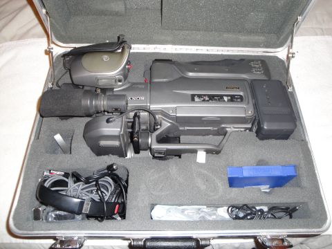 1993 Ford Taurus - A Sony video camera and its accessories are neatly organized within a silver carrying case.