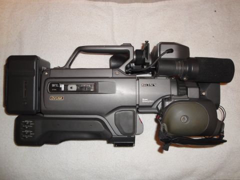 1993 Ford Taurus - Sony DVCAM camcorder, model number not visible, with attached microphone and battery.