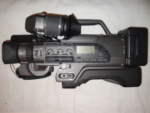 1993 Ford Taurus - A gray video camera is shown from the side, displaying its various controls and components.