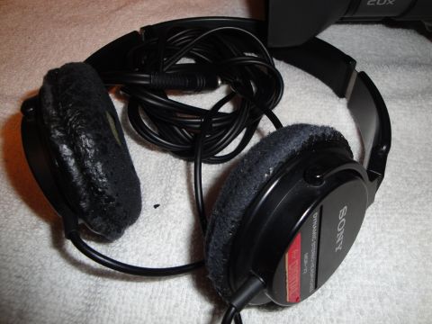 1993 Ford Taurus - A close-up view of a pair of Sony headphones, showing their worn earpads and coiled cord.