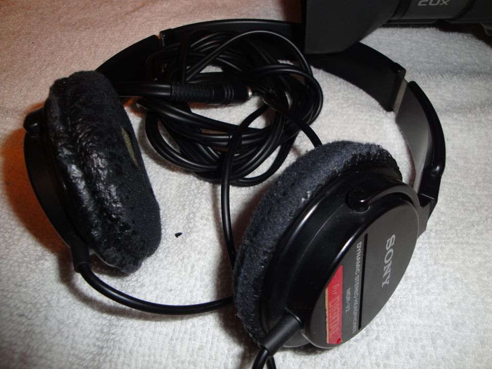 Pair of Sony headphones with tangled cord. Earpads are worn
