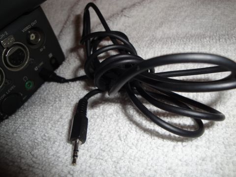 1993 Ford Taurus - A black audio cable is connected to a video device with various ports visible.