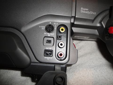 1993 Ford Taurus - Close-up view of the input and output ports on a camcorder, including S-Video, DV, and audio/video connections.