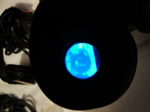 1993 Ford Taurus - A pair of headphones with a circular blue illuminated lens is visible in the frame.