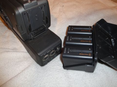 1993 Ford Taurus - A Sony camcorder base unit is shown with three InfoLithium batteries in a charging cradle.