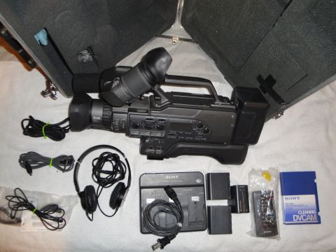 1993 Ford Taurus - A Sony camcorder and its accessories are laid out on a white surface next to an open case.