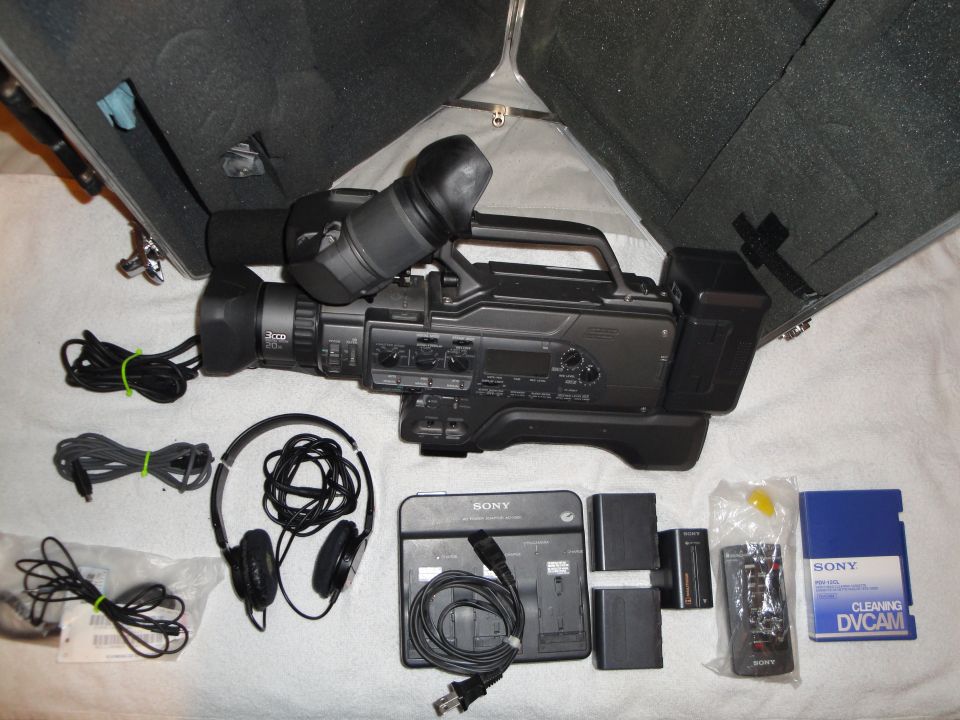 Sony camcorder with headphones, batteries, charger, and DVCAM tape