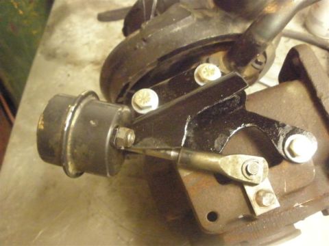 1994 Ford F-350 - This is a close-up view of a turbocharger wastegate actuator and its linkage mechanism.
