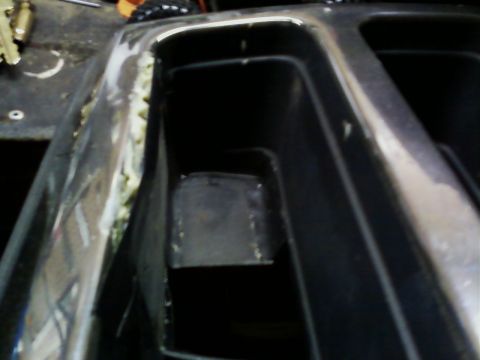1990 Ford Bronco - Close-up of chrome trim and black plastic interior, possibly from a vehicle's dashboard or console.