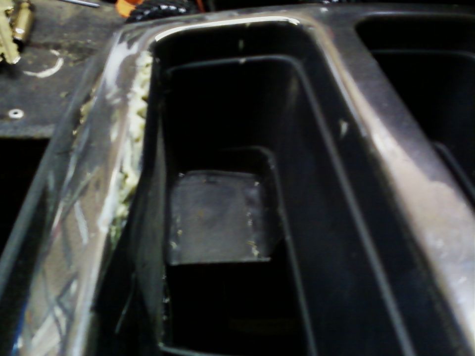 Chrome trim with yellow adhesive and black plastic interior