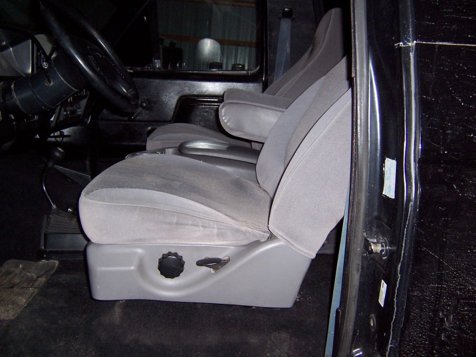 Gray cloth bench/bucket seats inside a truck cab