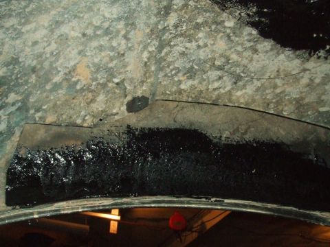 1996 Ford Bronco - Underside view of a vehicle's metal components, possibly showing rust or damage.