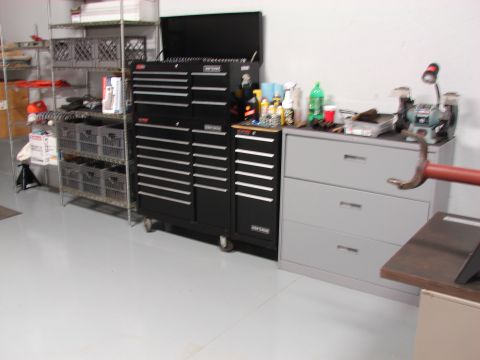 1996 Jeep Grand Cherokee - A workshop scene multiple tool chests and a filing cabinet, with a grinding wheel visible on the right.