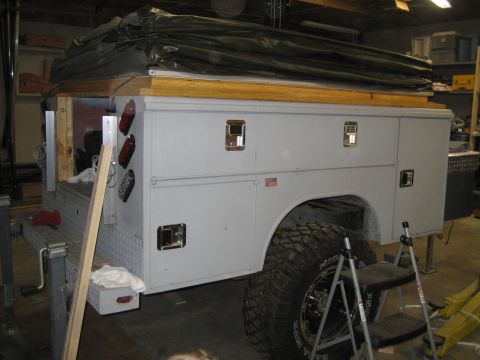 1996 Ford Bronco - A modified truck bed with a camper shell and toolboxes is shown from the side, with large off-road tires.