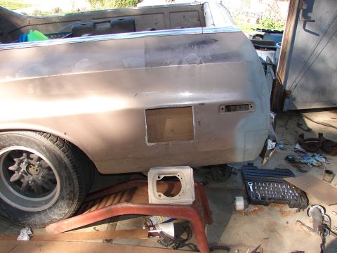 1973 Ford Ranchero - This image shows the rear quarter panel of a pickup truck bed, appearing to be in a state of repair or modification, with a square cutout a…