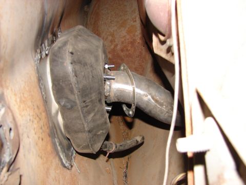 1973 Ford Ranchero - Close-up view of an exhaust pipe assembly, showing a rubber mount and bolted connections.