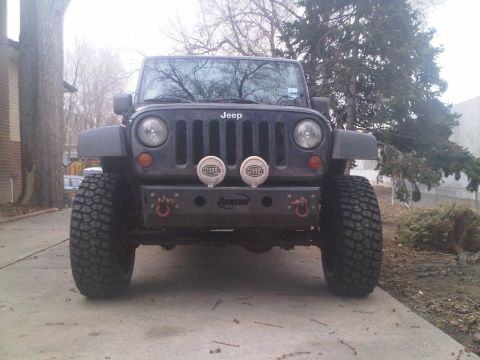 2008 Jeep Wrangler - This Jeep Wrangler features an aftermarket bumper and large off-road tires, suggesting it's a model from the JK generation.