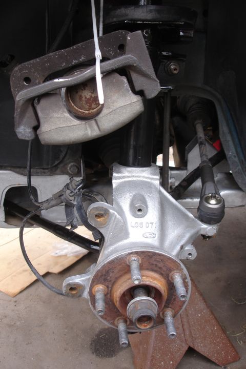 1995 Ford Taurus - The brake caliper and hub assembly are visible, with some rust on the rotor.