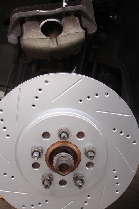 1995 Ford Taurus - Close-up view of a vehicle's brake caliper and rotor assembly.
