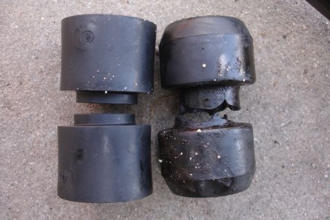 1995 Ford Taurus - Comparison of a worn-out suspension component next to a new one, highlighting the damage.