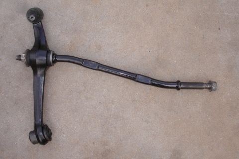 1995 Ford Taurus - Automotive suspension part, likely a front lower control arm, shown on a concrete surface.