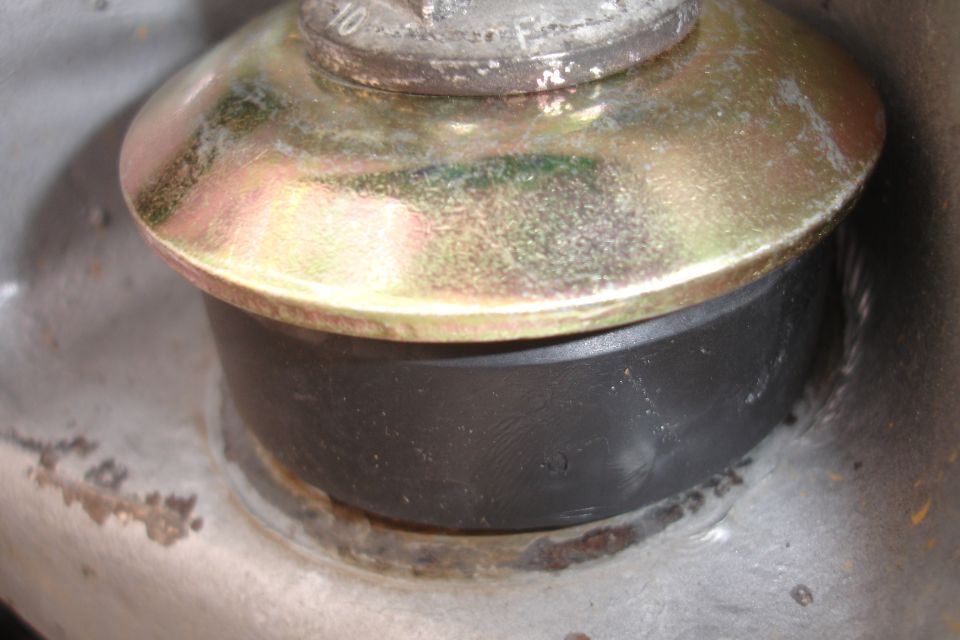 Close-up of a rubber bushing between metal components, likely part of a vehicle's suspension