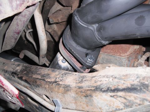 1991 Ford Bronco - Close-up view of the exhaust manifold and y-pipe connection, showing bolted flanges.