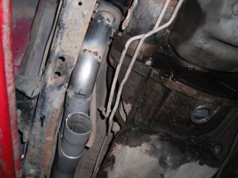 1991 Ford Bronco - A custom exhaust pipe is being welded into place on the underside of a vehicle.