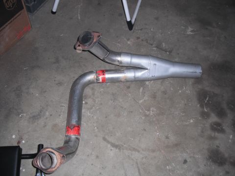 1991 Ford Bronco - Exhaust y-pipe with red markings and flange connections is shown on a concrete floor.