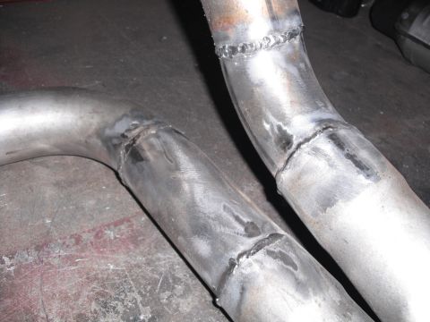 1991 Ford Bronco - Close-up view of custom exhaust pipes with visible welds.