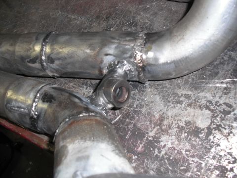 1991 Ford Bronco - This image shows a custom-fabricated exhaust pipe section with a welded T-fitting.
