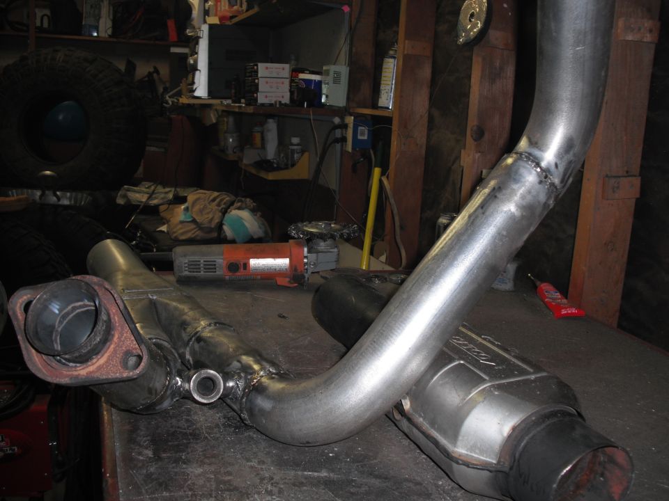 Custom exhaust y-pipe and catalytic converter on workbench