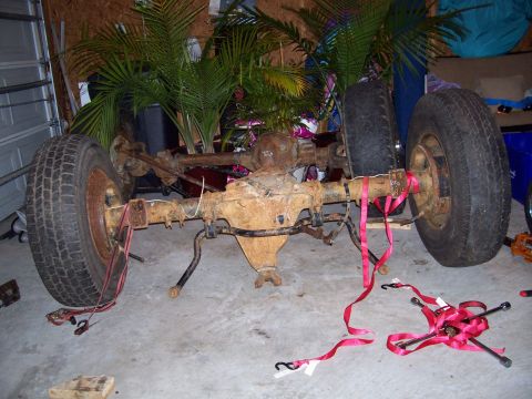 1994 Ford Bronco - Rear axle assembly with tires, likely for a truck or SUV, indoors.