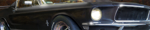 Banner crop of a black Mustang fastback front quarter with lit headlight and grille