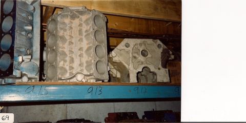 1973 Ford Mustang - Two engine blocks are stored on a shelf, with handwritten numbers below them.