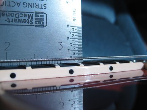 1989 Mazda MX-6 - A ruler measures the string height on a guitar fretboard, indicating a measurement of approximately 2.5 inches.