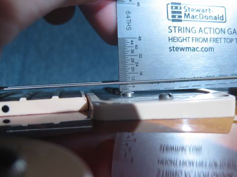 1989 Mazda MX-6 - Using a string action gauge to measure height from fret top to string.
