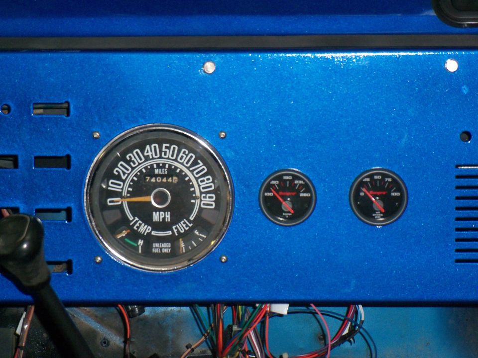 Dashboard with speedometer, fuel gauge, temperature gauge, and oil pressure gauge. Speedometer shows 74,044 miles