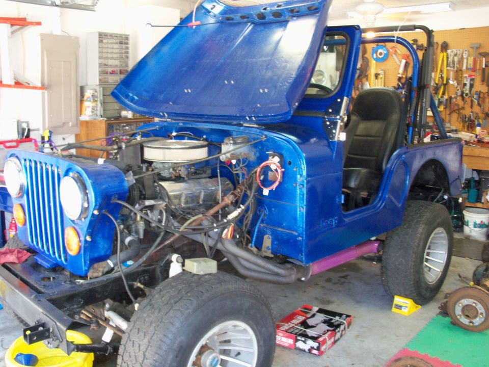 Blue 1978 Jeep CJ5 with hood open, showing engine and interior. Front view