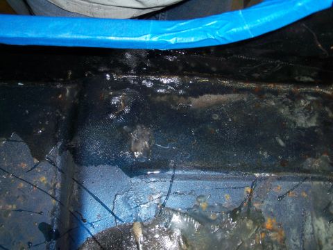 1978 Jeep CJ5 - This is a close-up view of a vehicle's floor pan, showing rust and wetness.