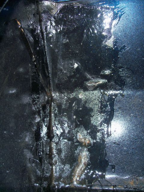 1978 Jeep CJ5 - Close-up view of the undercoating on a 1978 Jeep CJ5, revealing its textured layers and protective coating.