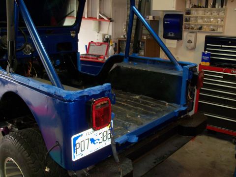 1978 Jeep CJ5 - 1978 Jeep CJ5 in a garage, possibly being prepped for paint or repair. Florida plate P07 386 is visible.