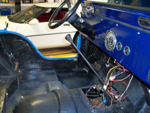 1978 Jeep CJ5 - Interior view of a 1978 Jeep CJ5, showing the blue dashboard, steering wheel, and exposed wiring.