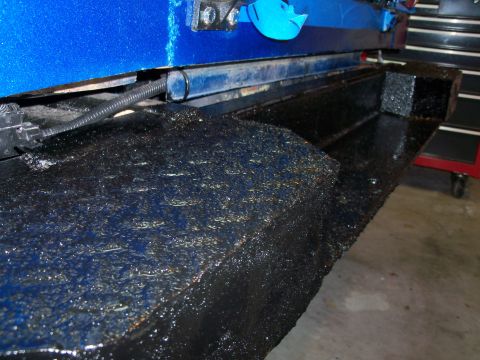 1978 Jeep CJ5 - Close-up of a textured blue and black metal component, possibly part of a vehicle's undercarriage or frame.