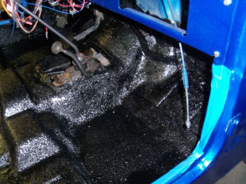 1978 Jeep CJ5 - The interior of a blue Jeep features a black textured floor and a manual transmission shifter.