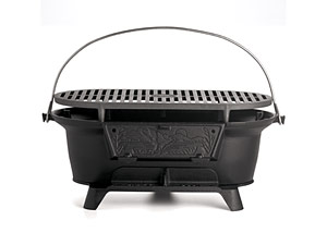 1990 Ford Bronco - Cast iron charcoal grill with folding grate and handle, isolated on white.