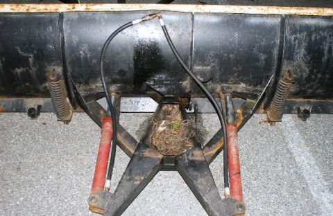 1979 Ford Bronco - This snow plow attachment features red hydraulic cylinders and black hoses, mounted on a vehicle.