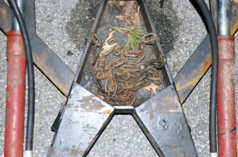 1979 Ford Bronco - Close-up of a trailer hitch assembly containing a pile of rusty chains.